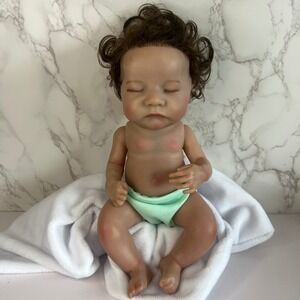 Realistic 11" Sleeping Baby Doll – Brown Curly Hair, Closed Eyes, Gender Neutral